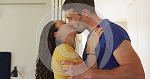 Happy caucasian couple in love hugging and kissing at home