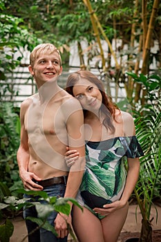 Young couple of soon to be parents at tropical forest