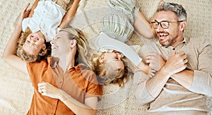 A happy Caucasian family of four lying in the living room at home. Loving smiling family being affectionate on the