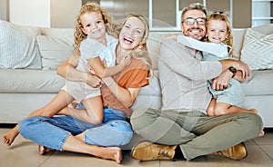 A happy Caucasian family of four relaxing in the living room at home. Loving smiling family being affectionate on the