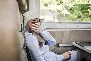 Caucasian Girl Laughing While Seating Inside a Camper Van photo