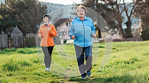 Happy caucasian grandmother and granddaughter running together. Old and young women in sports clothes, jogging in the