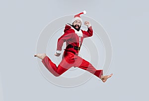 Happy caucasian man jumping on christmas party, santa claus