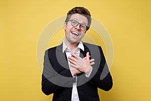 Happy caucasian man in suit being content to hear compliment