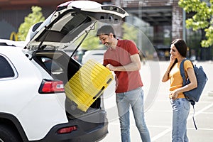 Happy caucasian millennial couple going car trip together