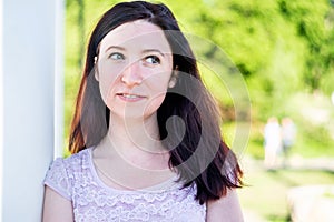 Happy caucasian woman outdoors in the park looking away