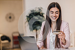 Happy caucasian woman in a suit, checking credit score online