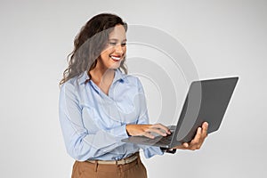 Happy caucasian young businesswoman professional typing on computer, chatting
