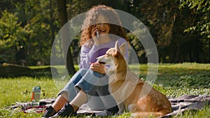 Happy Caucasian young girl pet friendly woman female handler joyful lady talking mobile phone laughing playing with cute