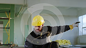 Happy and charismatic construction worker man have a fun time at construction site he wearing safety helmet and special