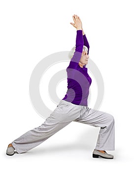 Happy charming beautiful elderly woman doing exercises while working out playing sports