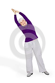 Happy charming beautiful elderly woman doing exercises while working out playing sports