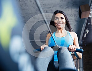 Happy charming woman working out at gym
