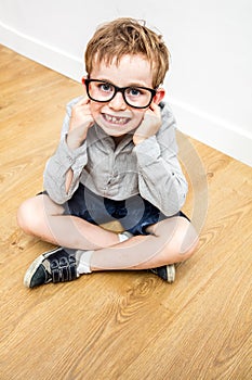 Happy cheeky child disagreeing for self-respect, high angle view photo