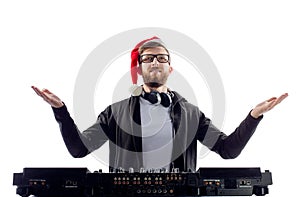 Happy cheerful Bearded man dj in Santa& x27;s hat and glasses plays music on a turntable raises hands up.