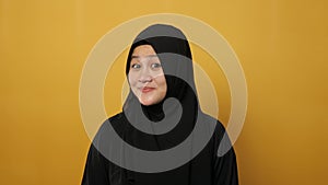 Happy cheerful beautiful Asian muslim woman looking at camera, smiling and nod her head, agreement or understanding concept