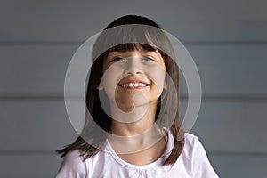 Happy cheerful black haired 7s girl looking at camera