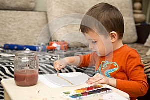 Happy cheerful child drawing with brush using a painting tools. Creativity concept. kids, children painting in kindergarten