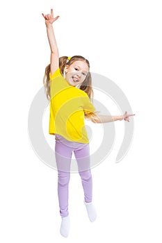 A happy and cheerful child dressed in a yellow T-shirt and purple pants plays, jumps.