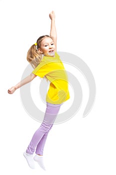 A happy and cheerful child dressed in a yellow T-shirt and purple pants plays, jumps.