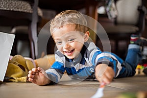 Happy cheerful child playing at home