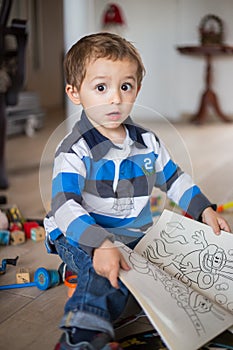 Happy cheerful child playing at home