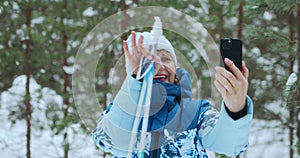 A happy cheerful elderly woman happily communicates via video calls