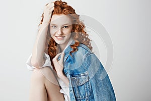 Happy cheerful foxy girl smiling looking at camera posing over white background.