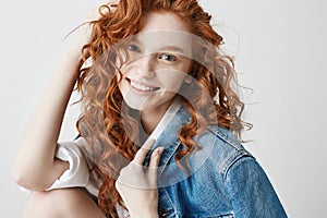 Happy cheerful foxy girl smiling looking at camera posing over white background.