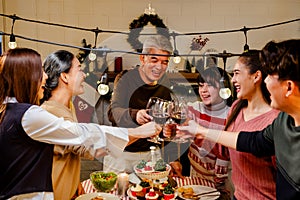 Happy and Cheerful group of extended Asian family has a toast and cheer during Christmas dinner at home. Celebration holiday