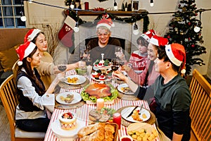 Happy and Cheerful group of extended Asian family has a toast and cheer during Christmas dinner at home. Celebration holiday