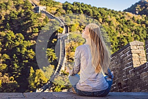Happy cheerful joyful tourist woman at Great Wall of China meditates on vacation trip in Asia. Girl visiting and