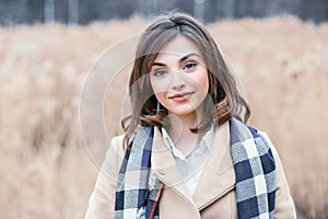 Happy and cheerful. Portrait of a woman smile no teeth outdoors autumn nature park background