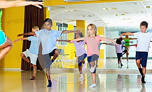 Preteen dancers practicing dance routine with female choreograph photo