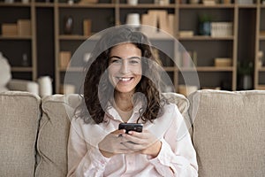 Happy cheerful smartphone user woman head shot home portrait