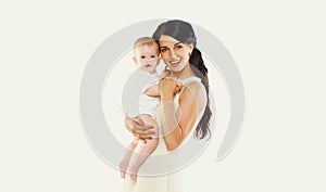 Happy cheerful smiling young mother holding baby on white background