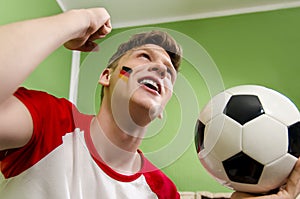 Happy cheerful teen, holding soccer ball