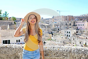 Happy cheerful tourist girl visiting Matera, Italy