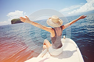 Happy and cheerful woman traveling on the boat