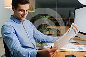 Happy cheerful young man celebrating success