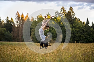 Happy cheerful young woman jumping in the air in the middle of g