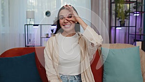 Happy cheerful young woman looking approvingly at camera showing ok gesture, positive like sign