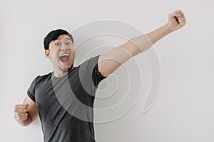 Happy and cheering funny face Asian man in black t-shirt isolated on white.