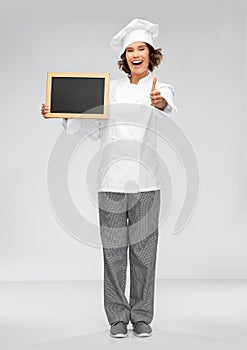 Happy chef with chalkboard showing thumbs up