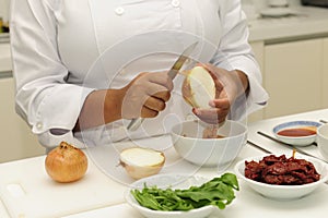 Happy chef cutting onions