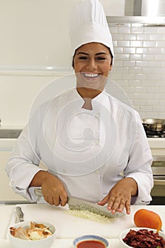 Happy chef cutting onions