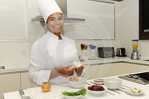 Happy chef cutting onions