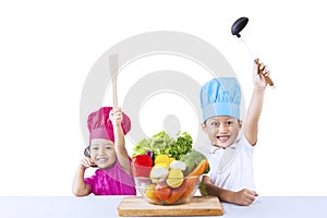 Happy chef and vegetables on white