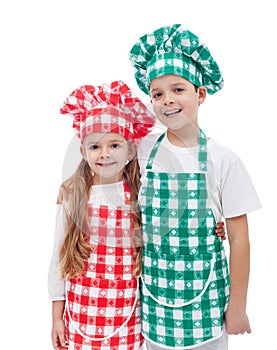 Happy chefs - boy and girl with aprons and hats