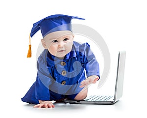 Happy child in academician clothes with laptop